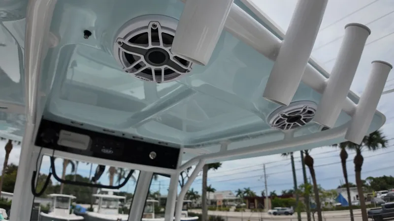 Slide: The Image of The image shows a boat's roof with speakers and fishing rod holders. - 33