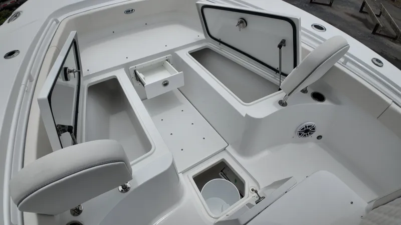 Slide: The Image of The image shows the cockpit of a Sea Hunt Ultra 265 SE boat with multiple storage compartments. - 37
