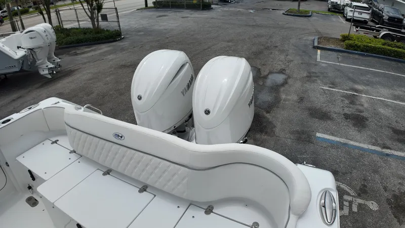 Slide: The Image of Two large outboard engines are mounted at the stern of a boat in a parking lot. - 10