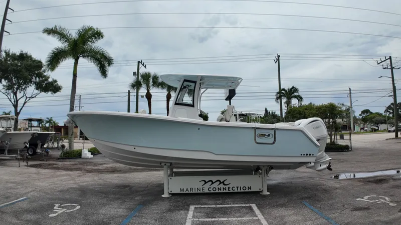 The Image of Sea Hunt Ultra 265 SE 2027 on a parking lot with palm trees in the background. - 1