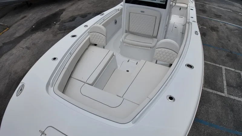 Slide: The Image of The image shows the deck of a 2027 Sea Hunt Ultra 265 SE boat with white upholstery. - 43