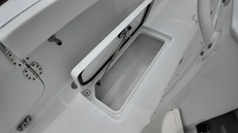 Slide: The Image of An open storage compartment on a 2027 Sea Hunt Ultra 265 SE boat. - 19