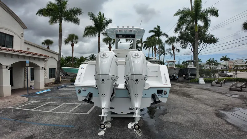 Slide: The Image of A 2027 Sea Hunt Ultra 265 SE boat with twin outboard engines, parked in a lot. - 4