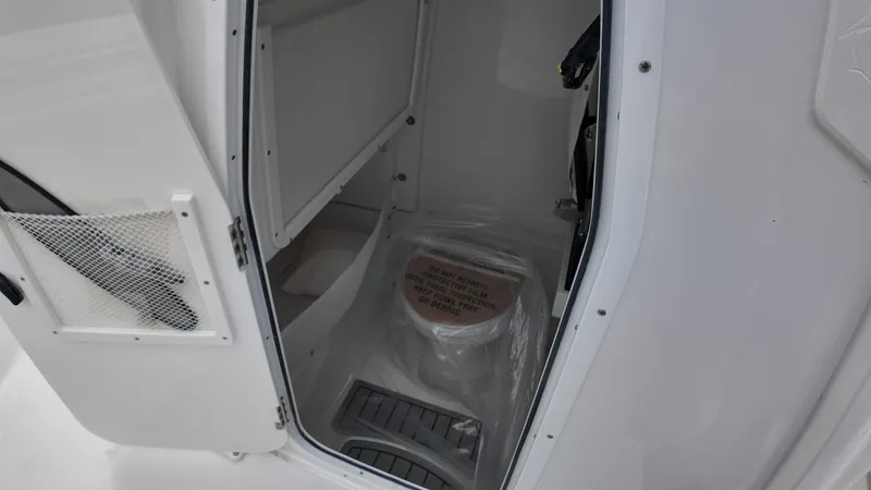 Slide: The Image of Interior of a 2027 Sea Hunt Ultra 265 SE with storage and cover. - 38