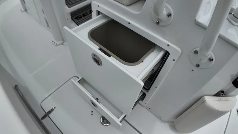 Slide: The Image of An open storage compartment on a 2027 Sea Hunt Ultra 265 SE boat. - 21