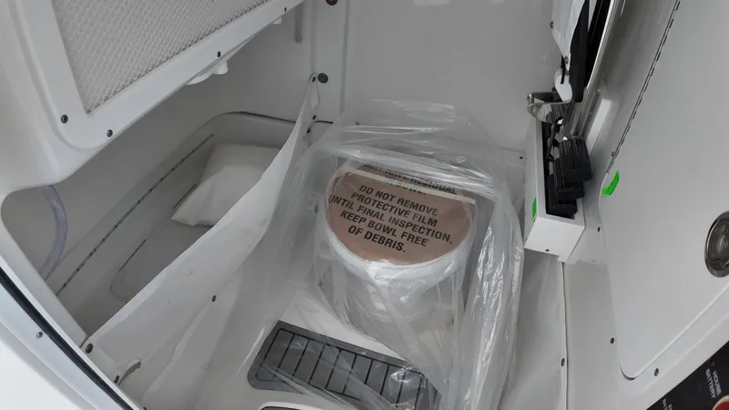 Slide: The Image of The image shows a toilet in a boat with protective film. - 39