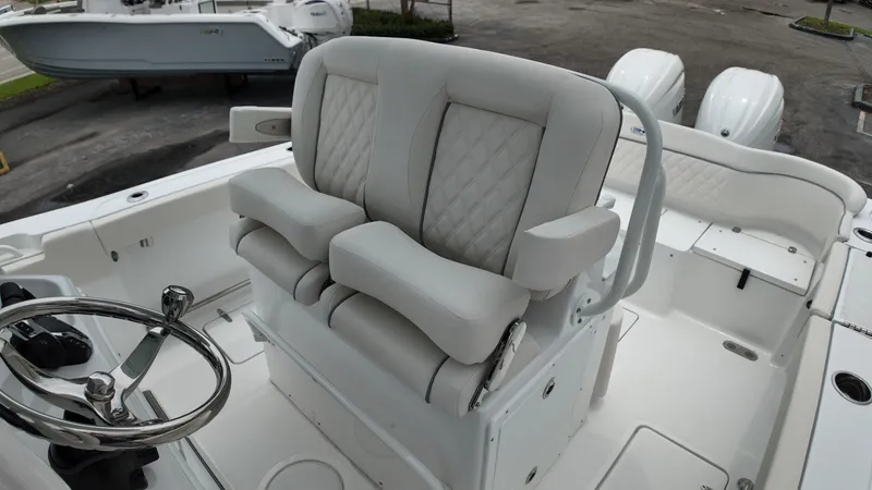 Slide: The Image of The image shows the helm of a Sea Hunt Ultra 265 SE with cushioned seats. - 29
