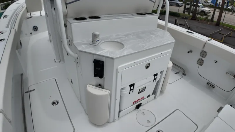 Slide: The Image of The image shows the cockpit of a 2027 Sea Hunt Ultra 265 SE boat with a console. - 15