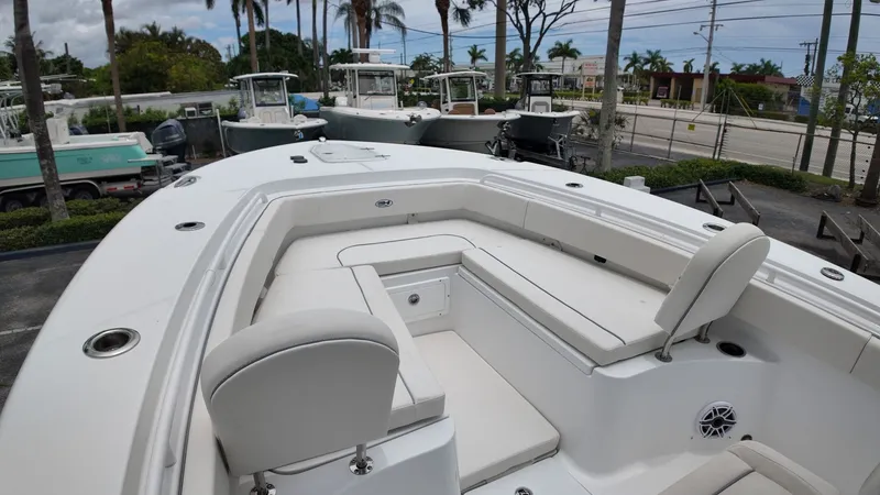 Slide: The Image of The image shows the deck of a Sea Hunt Ultra 265 SE boat with white seating. - 40
