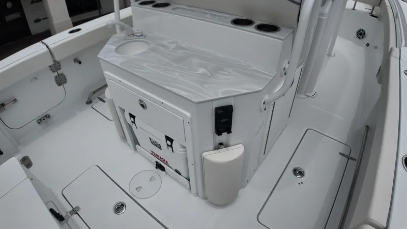 Slide: The Image of The image shows the cockpit of a Sea Hunt Ultra 265 SE boat with a sleek countertop. - 14