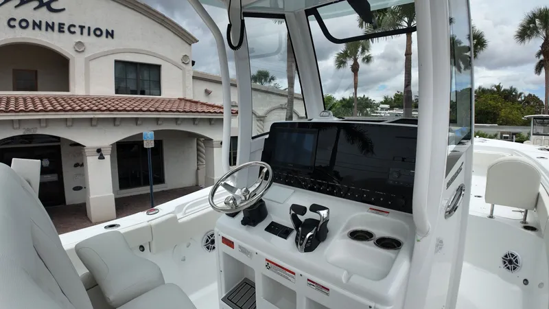 Slide: The Image of The image shows the cockpit of a 2027 Sea Hunt Ultra 265 SE boat. - 25