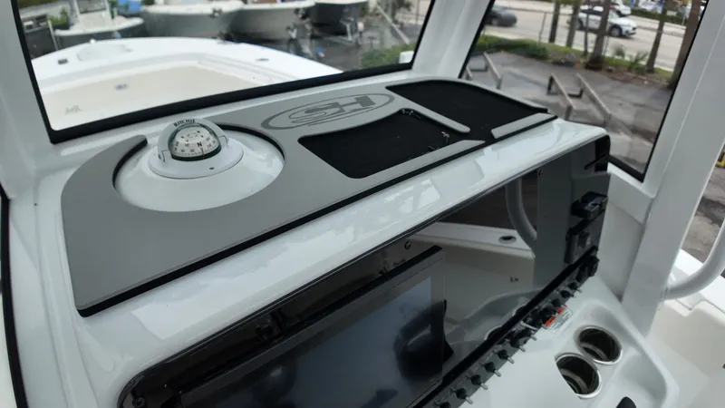 Slide: The Image of The image shows the cockpit of a Sea Hunt Ultra 265 SE boat with modern instruments. - 30