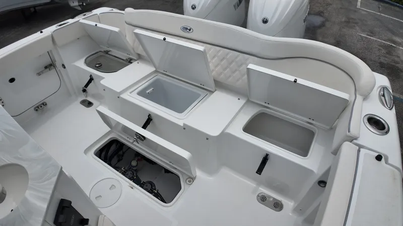 Slide: The Image of The image shows the stern of a Sea Hunt Ultra 265 SE boat with multiple storage compartments. - 13