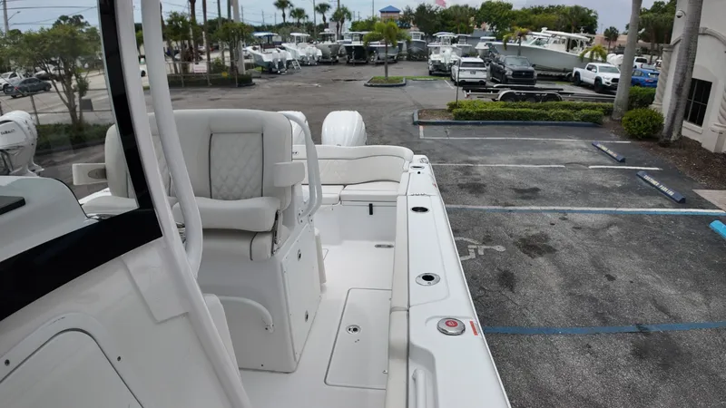 Slide: The Image of The image shows the deck of a Sea Hunt Ultra 265 SE boat parked in a lot. - 46