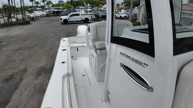 Slide: The Image of The image shows the deck of a Sea Hunt Ultra 265 SE boat parked in a lot. - 48