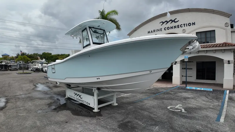 Slide: The Image of Sea Hunt Ultra 265 SE 2027 on a boat trailer in front of a building. - 6