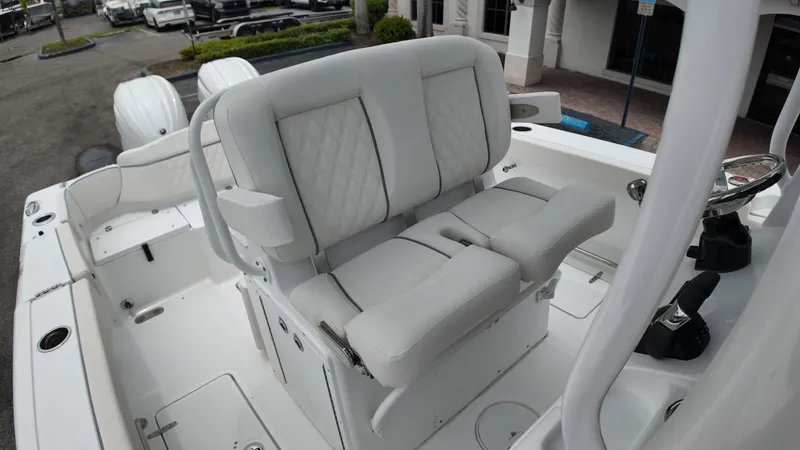 Slide: The Image of The image shows the helm of a Sea Hunt Ultra 265 SE boat with comfortable seating. - 28