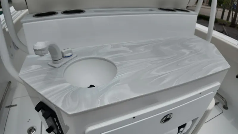 Slide: The Image of Interior view of the 2027 Sea Hunt Ultra 265 SE with sleek countertop and sink. - 17