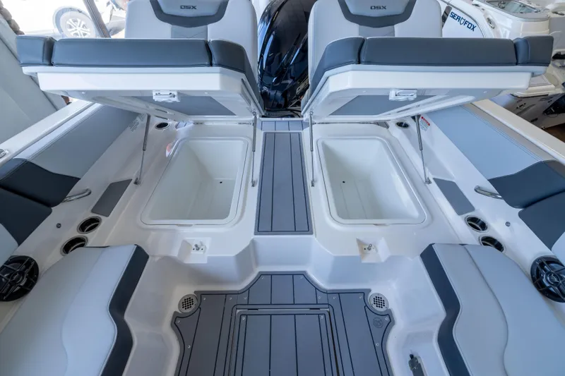 Slide: The Image of 2026 Chaparral 250 OSX boat interior with open storage compartments and seating. - 8