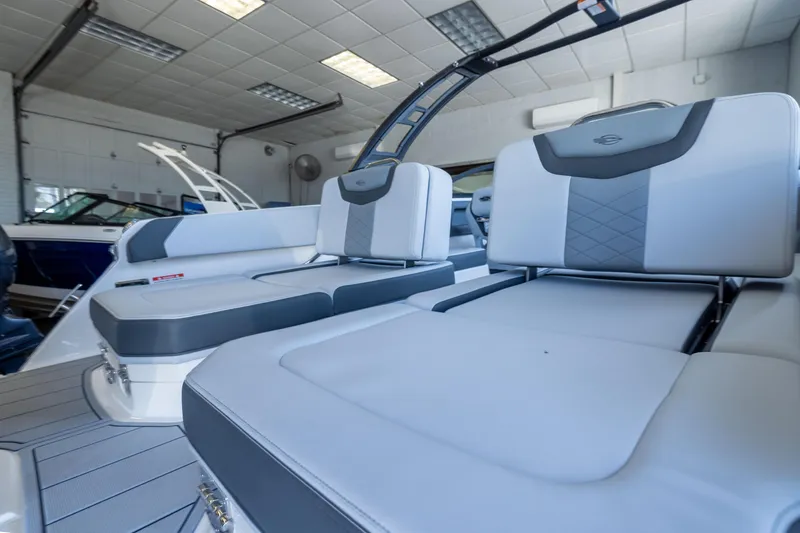 Slide: The Image of 2026 Chaparral 250 OSX boat interior with luxurious seating in a showroom. - 7