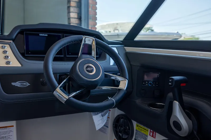 Slide: The Image of Interior view of 2026 Chaparral 250 OSX boat cockpit with steering wheel and controls. - 10