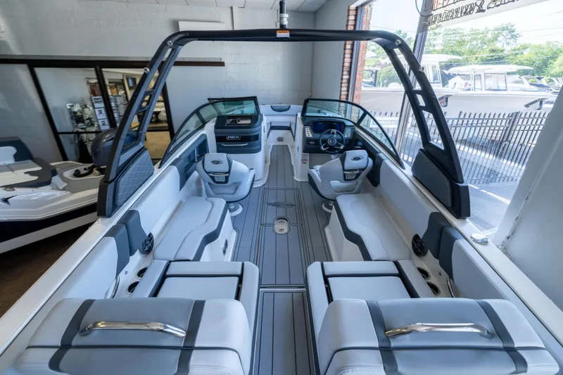 Slide: The Image of 2026 Chaparral 250 OSX boat interior with sleek seating and modern dashboard design. - 4