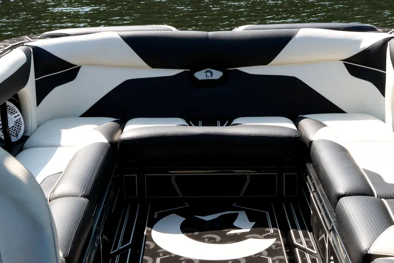 Slide: The Image of Luxurious seating on 2022 Centurion Ri265 boat, featuring sleek black and white upholstery. - 21