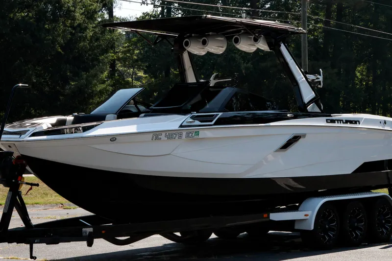 Slide: The Image of 2022 Centurion Ri265 boat on trailer, parked outdoors. - 24