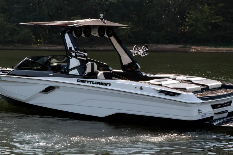 Slide: The Image of 2022 Centurion Ri265 boat on calm water, featuring sleek design and modern amenities. - 11