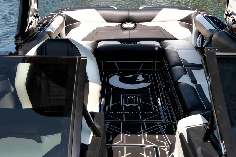 Slide: The Image of 2022 Centurion Ri265 boat interior with sleek black and white seating and modern design. - 20