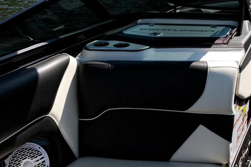 Slide: The Image of Interior of 2022 Centurion Ri265 boat with black and white seating and cup holders. - 15