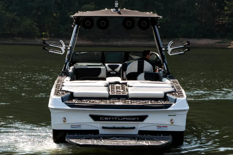 Slide: The Image of 2022 Centurion Ri265 boat cruising on a calm lake. - 8