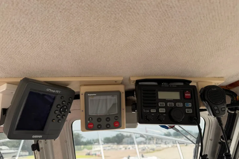 Slide: The Image of Boat dashboard with Garmin GPS, Raymarine display, and Icom radio on Osprey Expedition 26. - 5