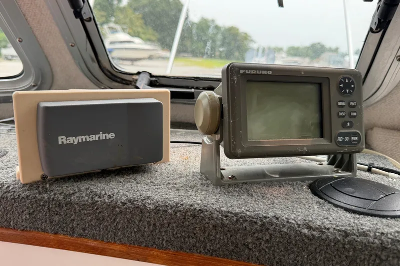 Slide: The Image of Boat dashboard with Raymarine and Furuno navigation devices on Osprey Expedition 26, 2004 model. - 4