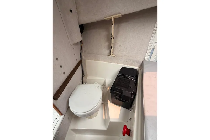 Slide: The Image of Compact boat bathroom in 2004 Osprey Expedition 26, featuring a toilet and storage box. - 9