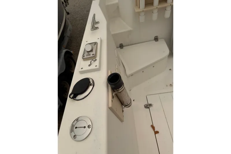 Slide: The Image of Interior view of a 2004 Osprey Expedition 26 boat, featuring control panel and rod holders. - 18