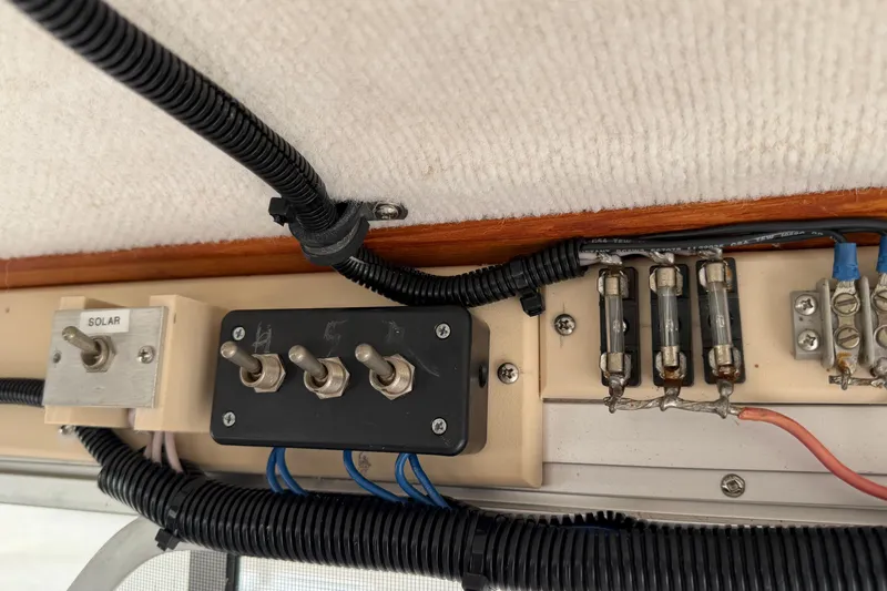 Slide: The Image of Electrical panel with switches and fuses in a 2004 Osprey Expedition 26 boat. - 7