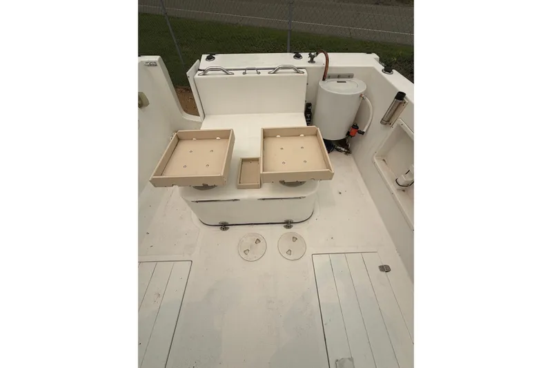 Slide: The Image of Interior of a 2004 Osprey Expedition 26 boat, featuring storage compartments and equipment. - 17