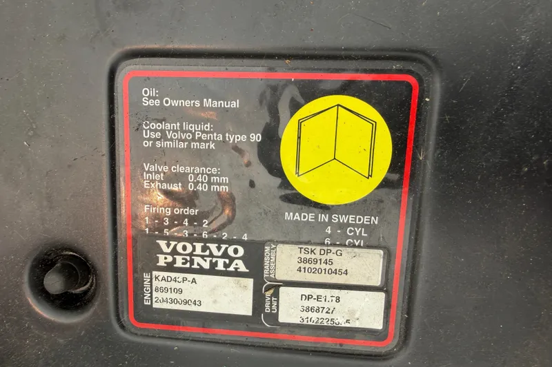 Slide: The Image of Close-up of a Volvo Penta engine label with technical specifications and a yellow manual icon. - 12