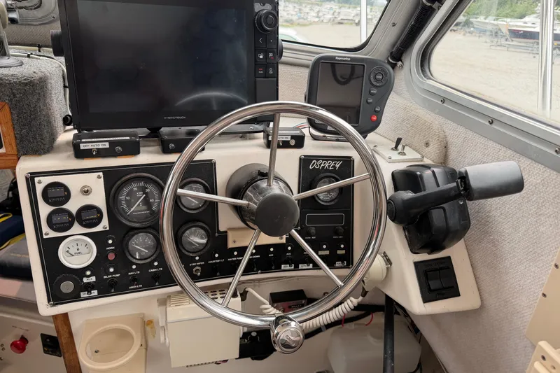 Slide: The Image of Boat cockpit of 2004 Osprey Expedition 26 with steering wheel and navigation instruments. - 2