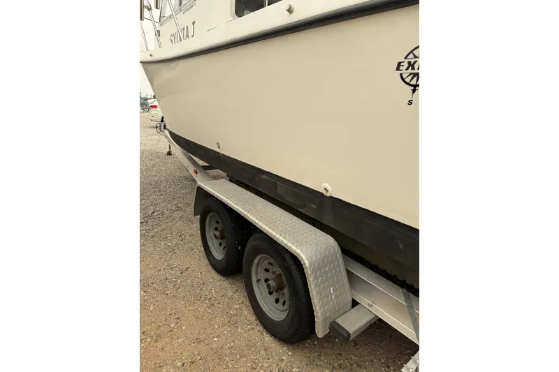 Slide: The Image of 2004 Osprey Expedition 26 boat on trailer, side view with dual wheels. - 22