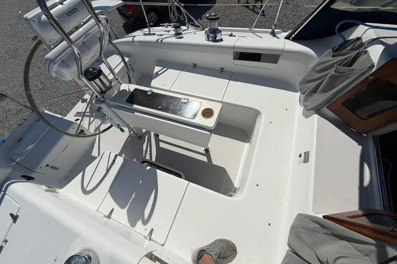 Slide: The Image of Cockpit of 2003 Catalina 380 sailboat with steering wheel and seating area. - 27