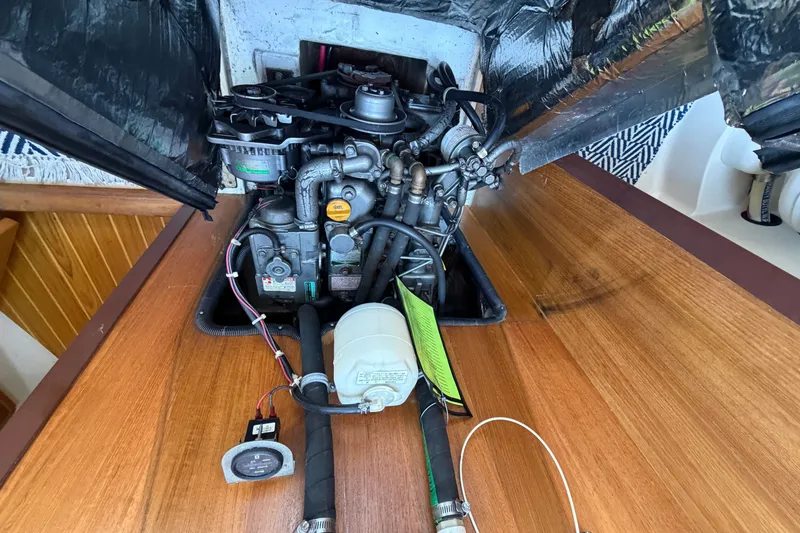 Slide: The Image of Engine compartment of a 2003 Catalina 380 sailboat, showcasing mechanical components. - 26
