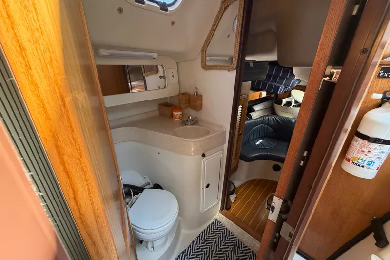 Slide: The Image of Interior of a 2003 Catalina 380 sailboat featuring a compact bathroom and cozy cabin area. - 12