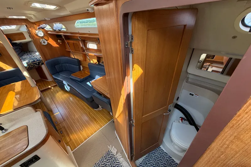 Slide: The Image of Interior of 2003 Catalina 380 sailboat with wood finish and seating area. - 11