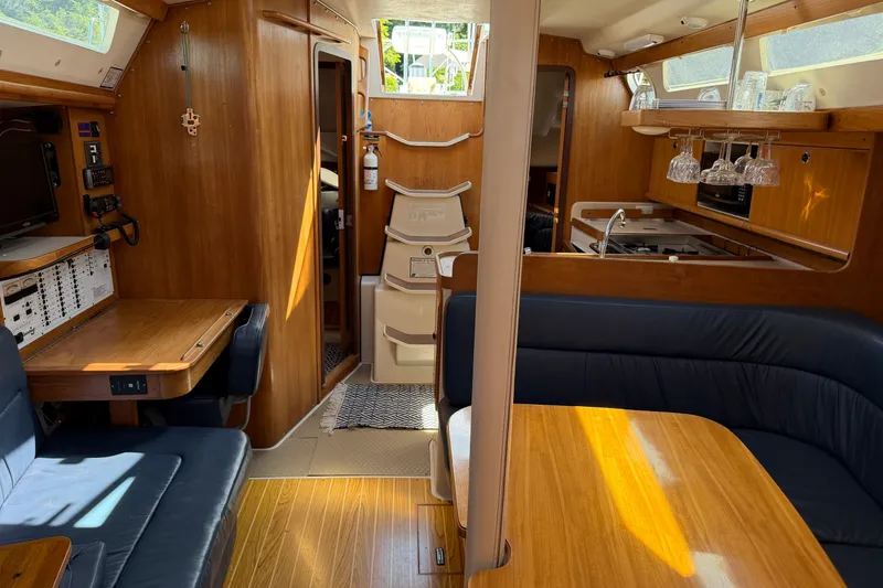 Slide: The Image of Interior of a 2003 Catalina 380 sailboat with wood finish and cozy seating area. - 23
