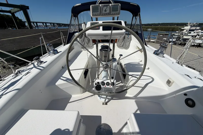 Slide: The Image of Cockpit view of a 2003 Catalina 380 sailboat with steering wheel and navigation instruments. - 5