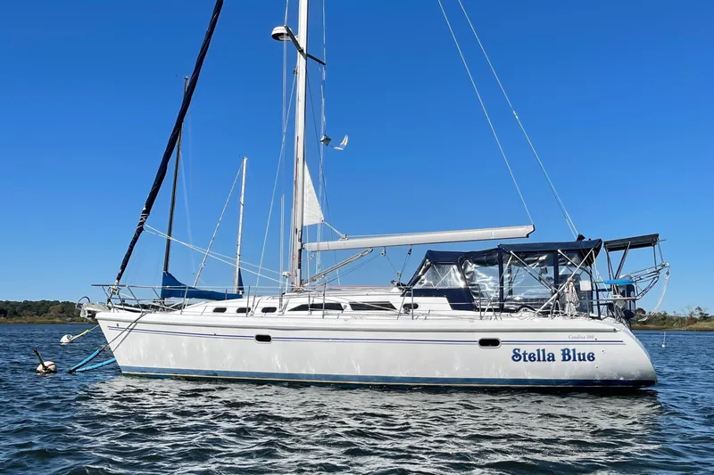 The Image of 2003 Catalina 380 sailboat on calm water under clear blue sky. - 0
