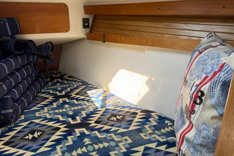 Slide: The Image of Cozy cabin interior of 2003 Catalina 380 sailboat with patterned bedding and cushions. - 21