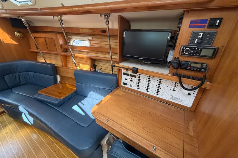 Slide: The Image of Interior of 2003 Catalina 380 yacht with blue seating and navigation equipment. - 3